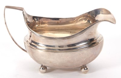 Lot 16 - A George III silver cream jug of oval form...