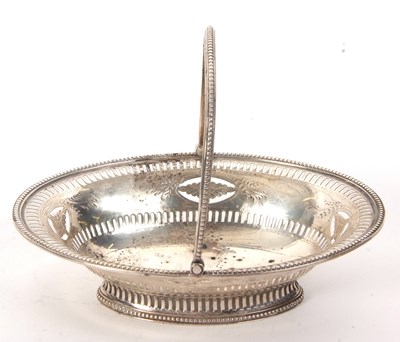 Lot 18 - A small George III swing handled silver basket...