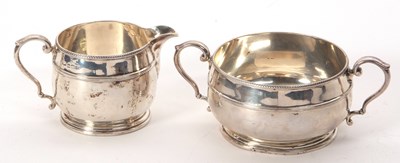 Lot 33 - A George V silver matching cream jug and twin...