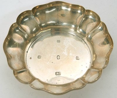 Lot 21 - A sterling silver dish with scallop rim border,...