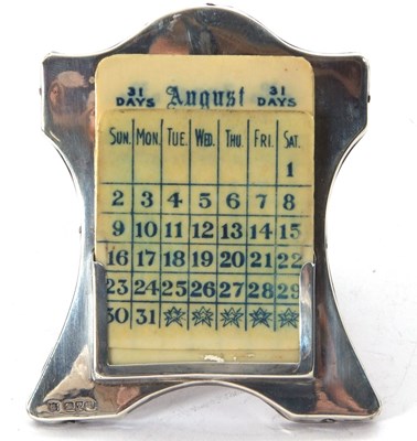 Lot 111 - An Edwardian silver framed desk calendar,...