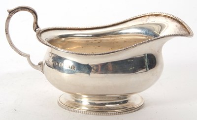 Lot 156 - A George V silver cream jug of plain oval form...