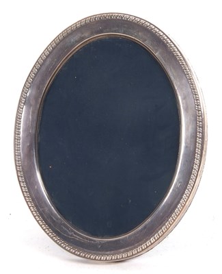 Lot 198 - A modern silver photograph frame of oval form...