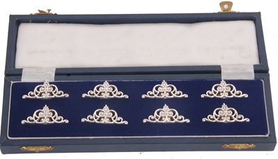 Lot 262 - A cased set of eight silver place card holders,...