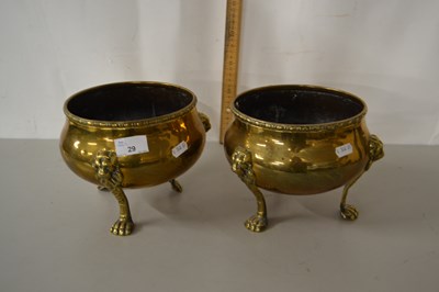 Lot 29 - A pair of brass three footed jardinieres
