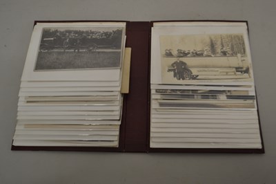 Lot 74 - An album of early black and white postcards...