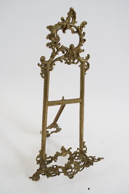 Lot 292 - Small brass table easel with foliate decoration
