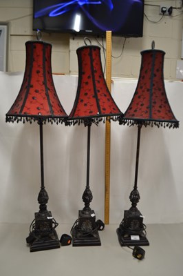 Lot 145 - A set of three modern table lamps with red and...