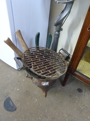 Lot 705 - Cast iron pot belly barbecue and garden tools