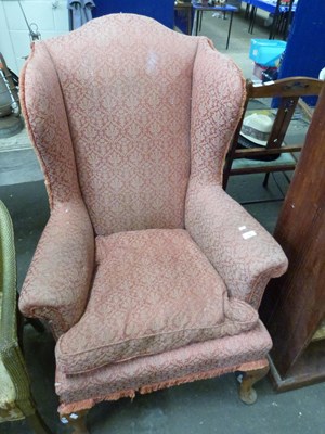 Lot 794 - An upholstered wing back armchair