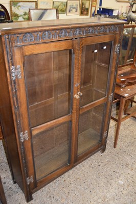 Lot 325 - 20th Century oak two door bookcase cabinet,...