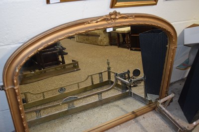 Lot 401 - An arched over mantel mirror set in a gilt...