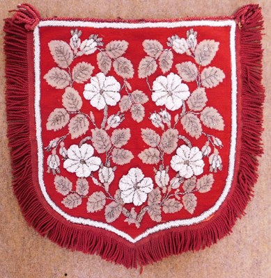 Lot 31 - A beaded screen/pennant, the red needlework...