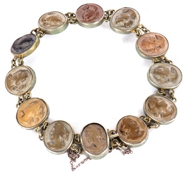 Lot 115 - A lava cameo bracelet, the oval lava cameos in...