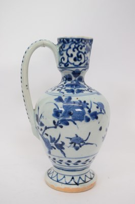 Lot 103 - Porcelain ewer with a blue and white design of...