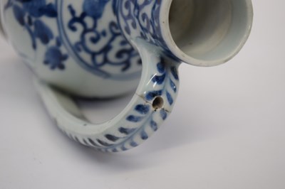 Lot 103 - Porcelain ewer with a blue and white design of...