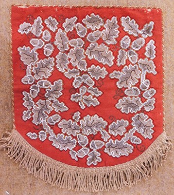 Lot 33 - A beaded screen/penant, the red needlework...