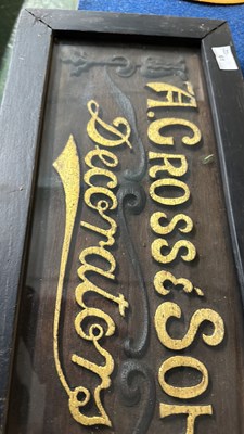 Lot 61 - A framed wooden sign with raised lettering...