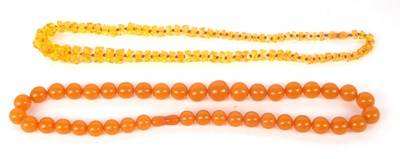 Lot 139 - Two amber bead necklaces, the first with round...