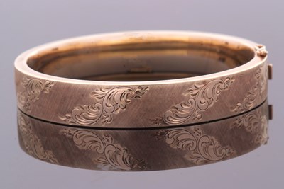 Lot 408 - A 9ct gold hinged bangle, the 12mm wide bangle...