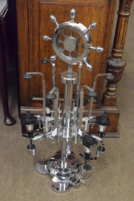 Lot 644 - A circular chrome finish revolving bar optic...