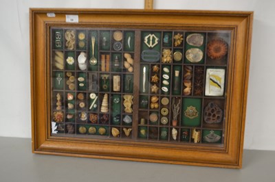 Lot 39 - A modern framed display of various trinkets...