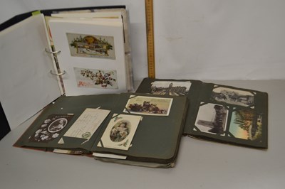 Lot 57 - A group of three albums of various postcards...