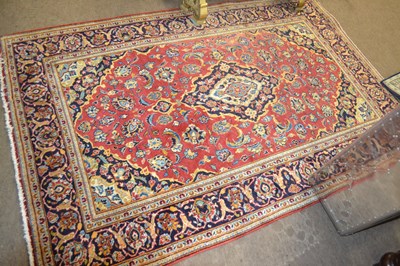 Lot 667 - A contemporary Kashan rug with central red...