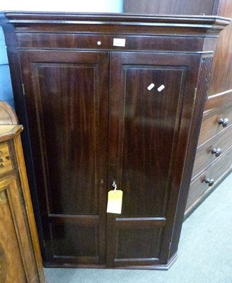 Lot 553 - A Georgian mahogany corner cabinet with two...