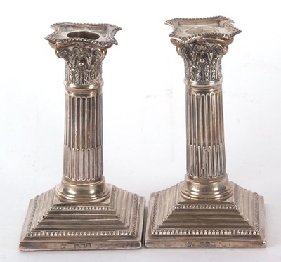 Lot 36 - A pair of late Victorian silver candlesticks...