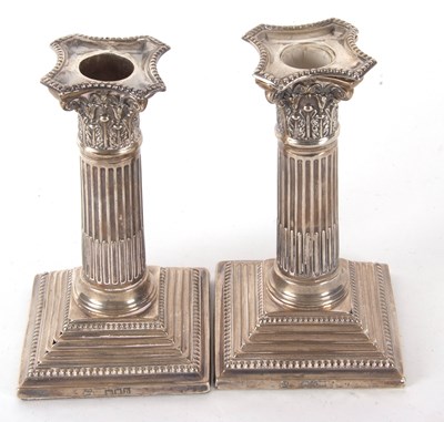 Lot 36 - A pair of late Victorian silver candlesticks...