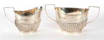 Lot 60 - An Edwardian silver cream jug and twin handled...