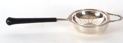 Lot 67 - A hallmarked silver tea strainer and drip bowl...