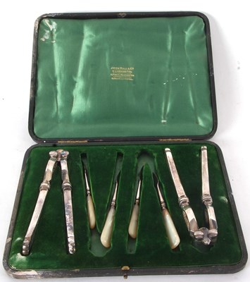 Lot 74 - A cased set two pairs of silver plated nut...