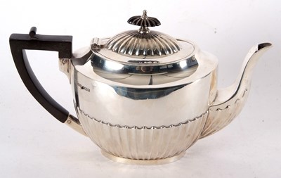 Lot 96 - A George V silver teapot, part fluted...