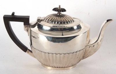 Lot 96 - A George V silver teapot, part fluted...