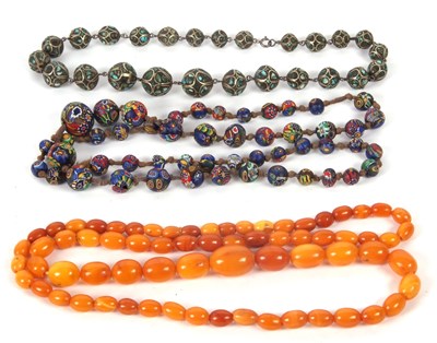 Lot 149 - A butterscotch amber bead necklace, the oval...