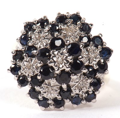 Lot 5 - A 9ct sapphire and diamond cluster ring, the...