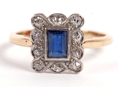 Lot 22 - A sapphire and diamond ring, the central...