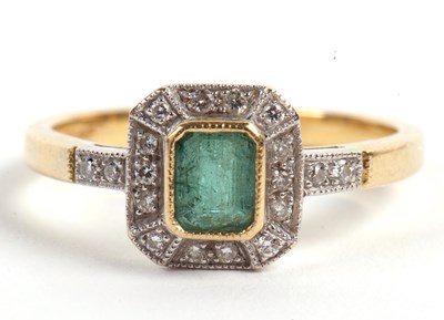 Lot 23 - An 18ct emerald and diamond ring, the central...