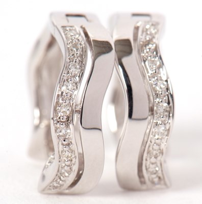 Lot 62 - A pair of 9ct and diamond earrings, the hoops...