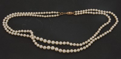 Lot 120 - A cultured pearl necklace, the two graduated...