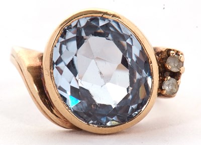 Lot 19 - A blue spinel and white stone ring, the oval...