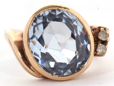 Lot 19 - A blue spinel and white stone ring, the oval...