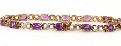 Lot 73 - A 9ct amethyst and diamond bracelet, the oval...