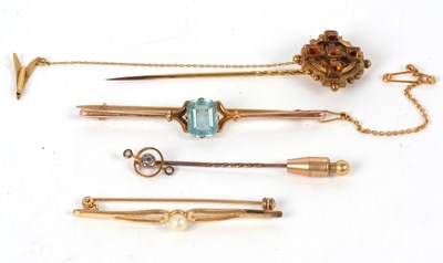 Lot 75 - Four brooches: to include a 9c and blue stone...