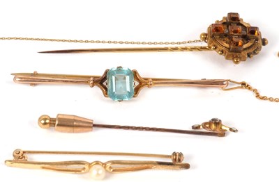 Lot 75 - Four brooches: to include a 9c and blue stone...