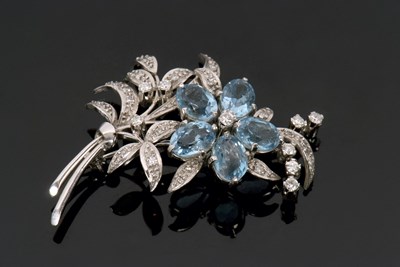 Lot 330 - An 18ct white gold diamond and topaz floral...