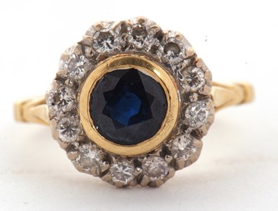 Lot 16 - An 18ct sapphire and diamond ring, the central...