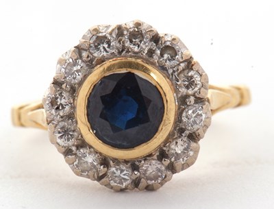 Lot 16 - An 18ct sapphire and diamond ring, the central...